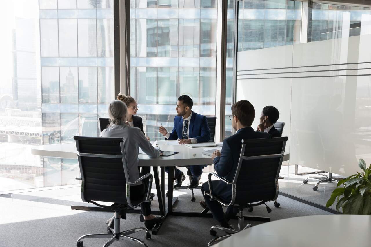 vários gestores reunidos para discutir estratégias para empresa matriz e filial.
